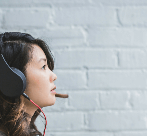 woman listening to music on spotify via headphones