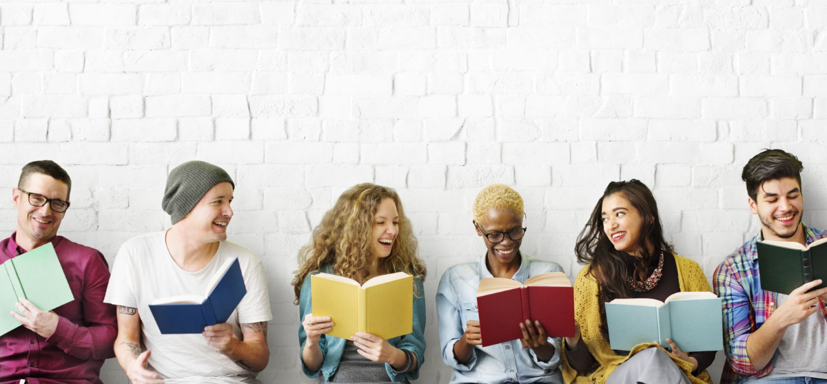 a group of young people reading books